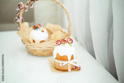 Traditional russian easter cake on table. The decorarion of kulich are the flower are eating on spring holiday photo