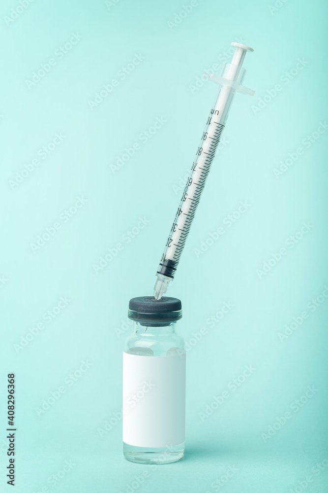 Medicine vaccine vials with blank label for text isolated over blue background Medicine vaccine vials with blank label for text isolated over blue background