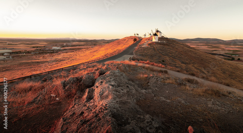 Windmills situed in Castilla la Mancha, Spain, captured during sunrise. photo