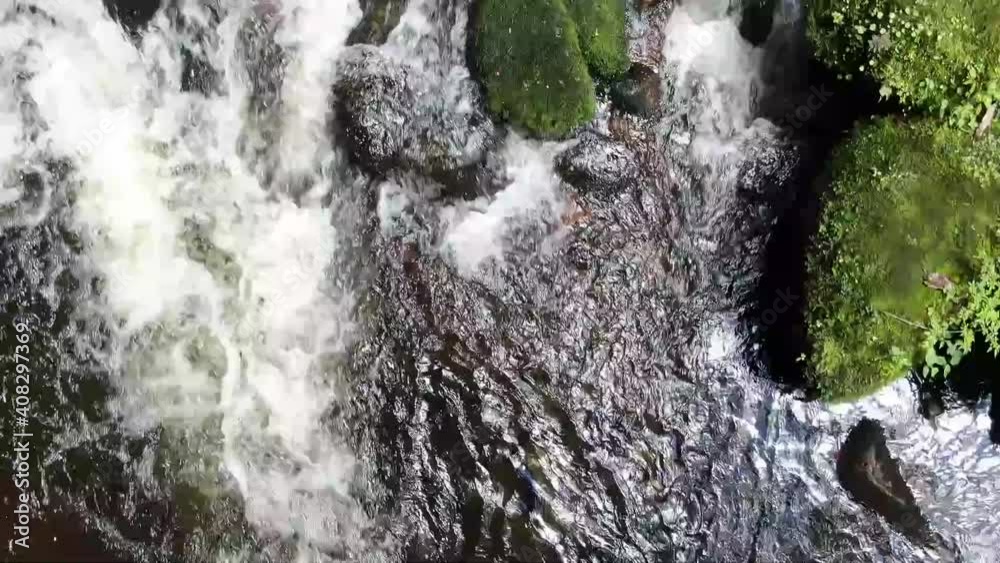 Stream flowing through rocky barro blanco river, Cundinamarca, Columbia. Directly above aerial view  