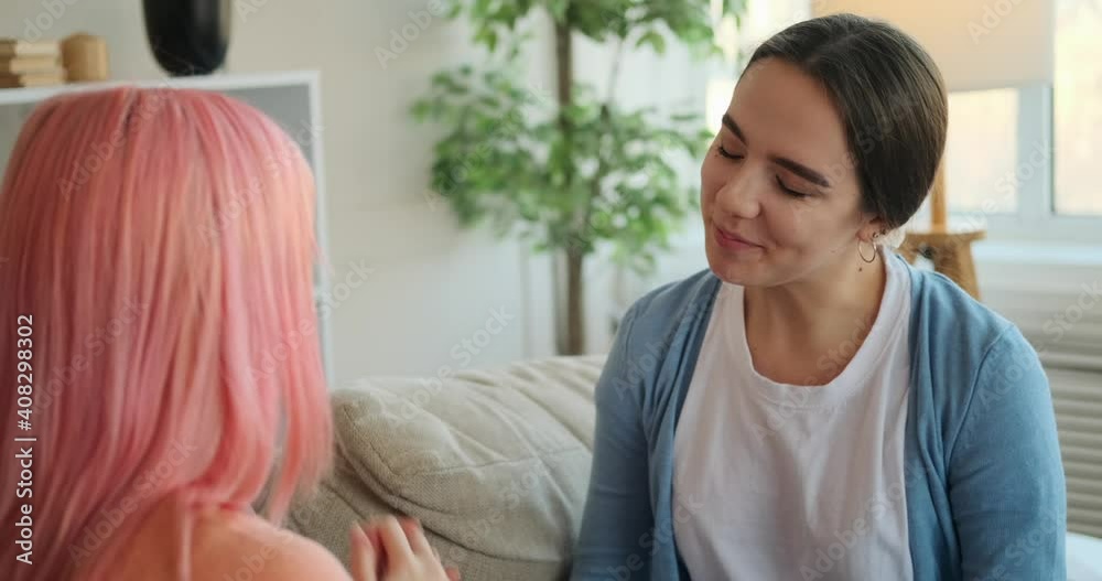 Gay woman proposing her girlfriend with a ring at home Gay woman proposing her girlfriend with a ring at home
