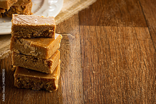 Paçoca, Brazilian Typical Peanut Candy on Wooden Table and a Plate photo