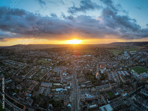 Aerial panoramic view of English market town at sunset