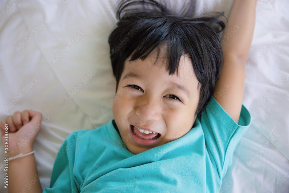Authentic close up of happy kid in a bed. Concept of new generation, family, parenthood, authenticity, Son. Authentic close up of happy kid in a bed. Concept of new generation, family, parenthood, authenticity, Son.