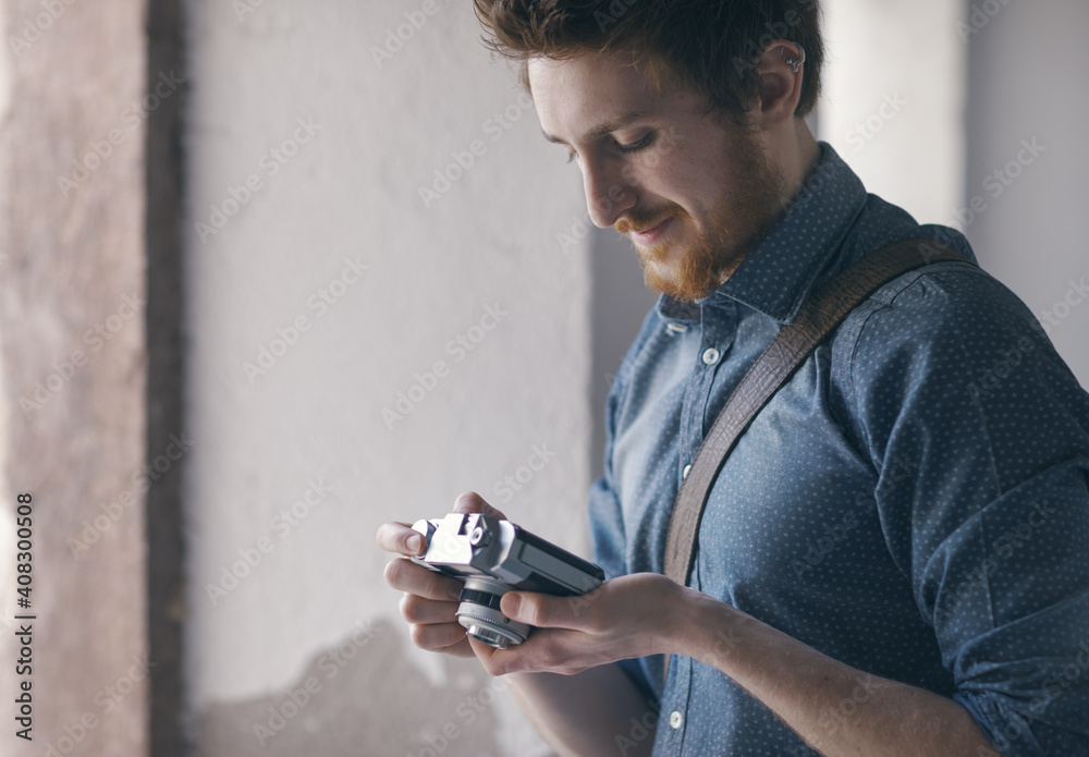 Fototapeta premium Hipster young man with vintage camera