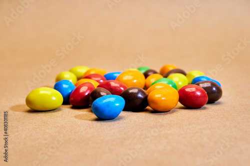 Colorful candies on a beige background
