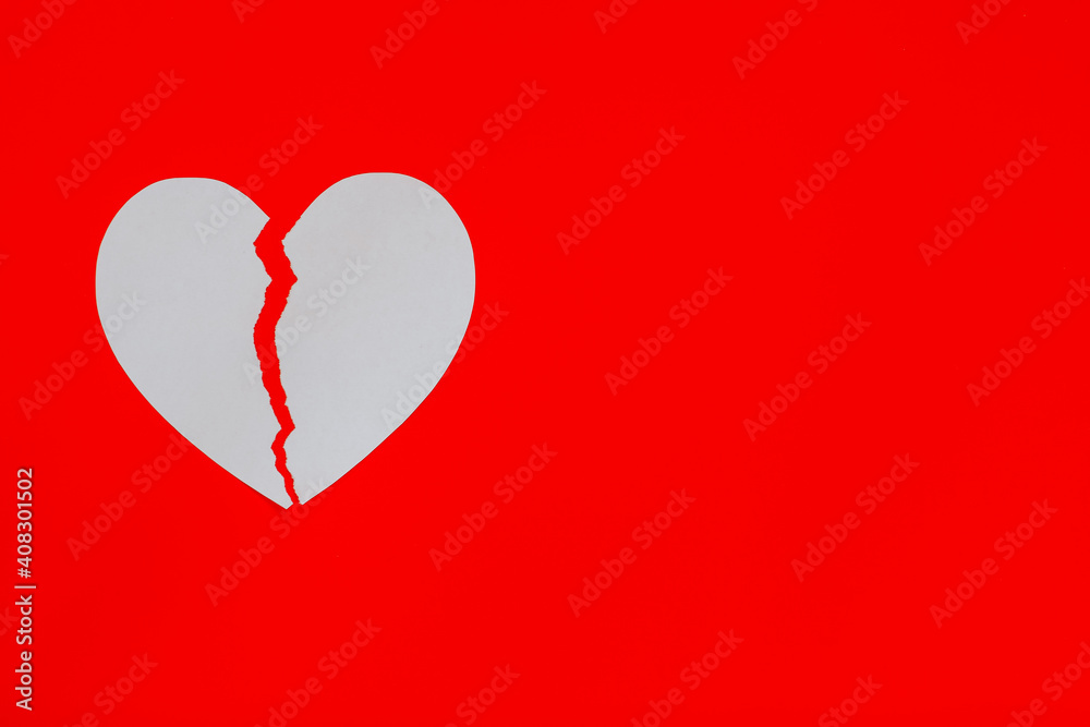 White broken heart on red background with copy space. White broken heart on red background with copy space.