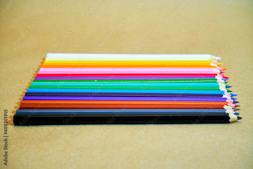 Colorful pencils on the table and in the stand Colorful pencils on the table and in the stand