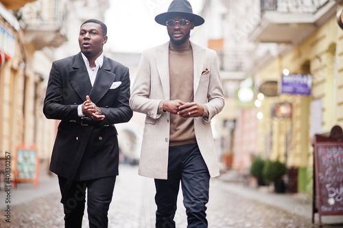 Obraz na plátně Two fashion black men walking on street