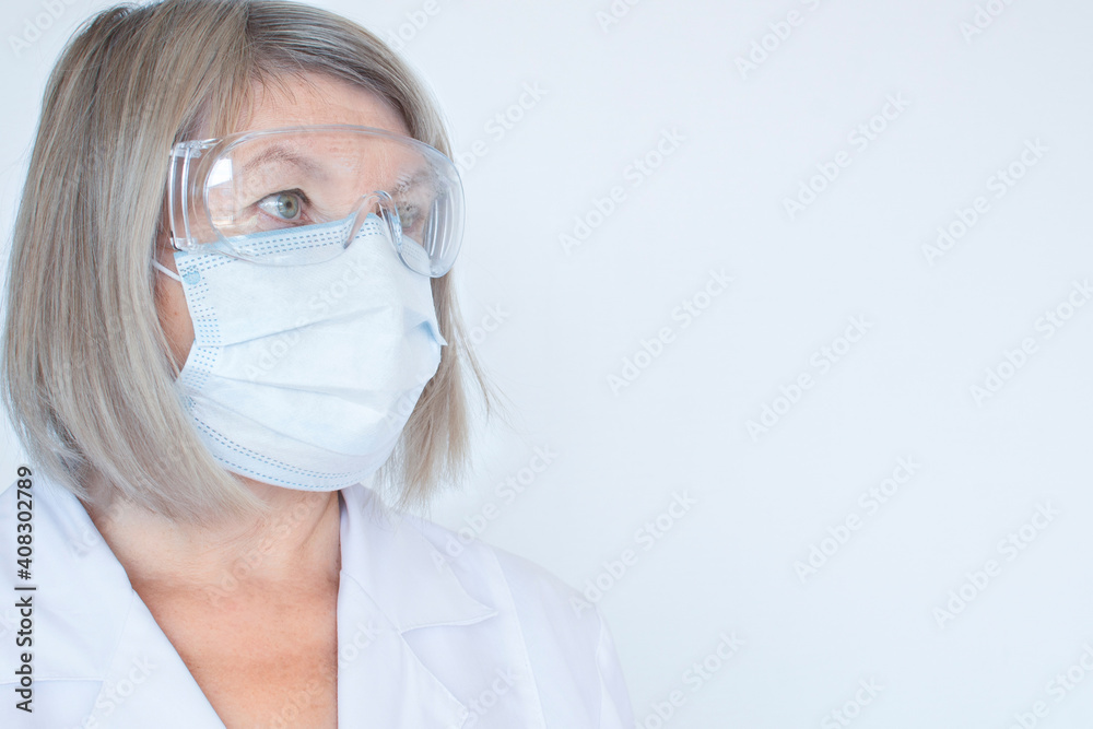 Adult doctor, nurse, infectious in goggles and medical mask disease scientist holds the flu, measles, coronavirus, covid-19 vaccination, prepares for vaccination. Medicine and drugs concept Adult doctor, nurse, infectious in goggles and medical mask disease scientist holds the flu, measles, coronavirus, covid-19 vaccination, prepares for vaccination. Medicine and drugs concept