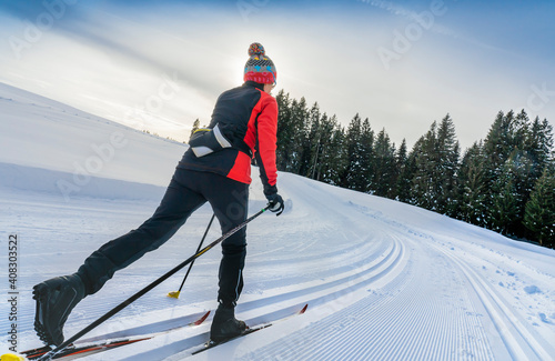 Bild auf Leinwand beautiful active senior woman cross-country skiing in fresh fallen powder snow i
