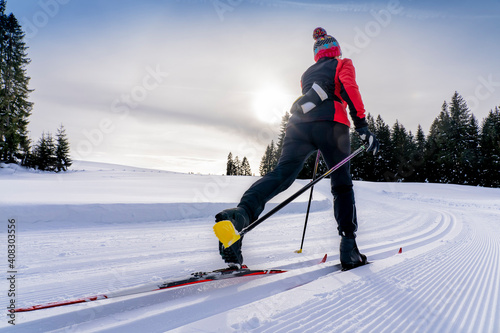 Bild auf Leinwand beautiful active senior woman cross-country skiing in fresh fallen powder snow i