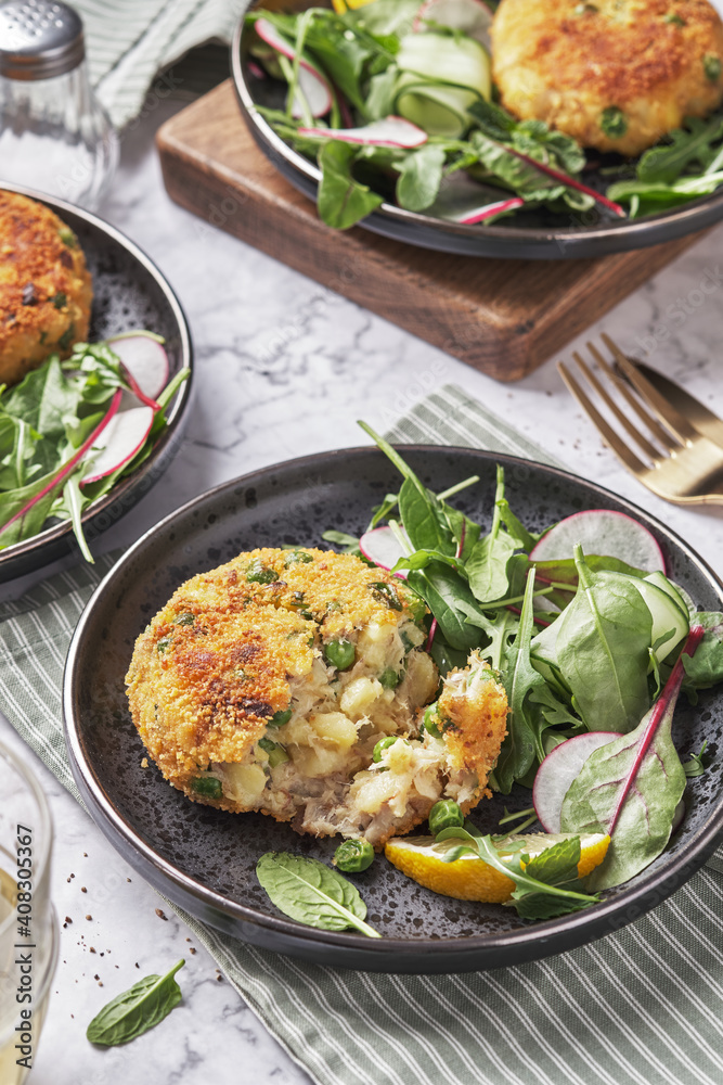 Smoked mackerel fishcakes served with a rocket, spinach salad Smoked mackerel fishcakes served with a rocket, spinach salad