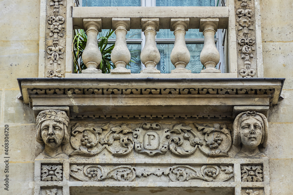 Fototapeta premium Traditional French house with typical balconies and windows. Paris, France.