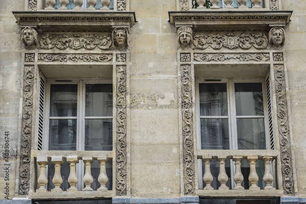 Obraz premium Traditional French house with typical balconies and windows. Paris, France.