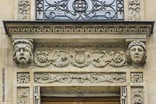 Traditional French house with typical balconies and windows. Paris, France.