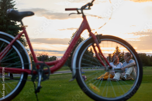 Fototapeta Naklejka Na Ścianę i Meble -  Red bicycle on the grass. Green lawn on the grass field.