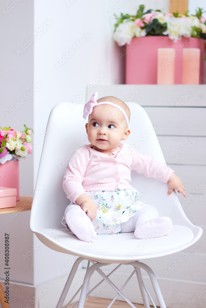 Funny little baby girl in pink bright modern interior. Mothers day concept..