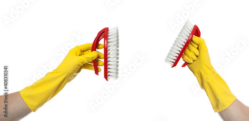 Hand in yellow glove with a red cleaning brush on a white background. Home cleaning concept