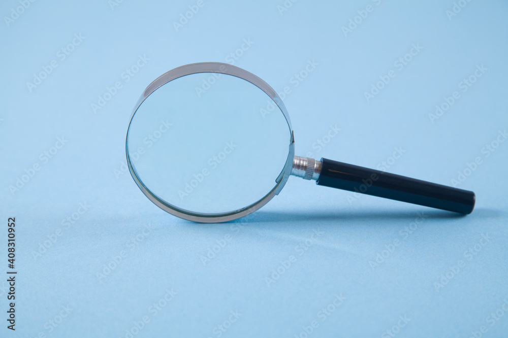 Magnifier on an isolated blue background.