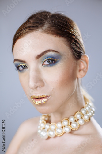 portrait of a girl with large white beads on a white background