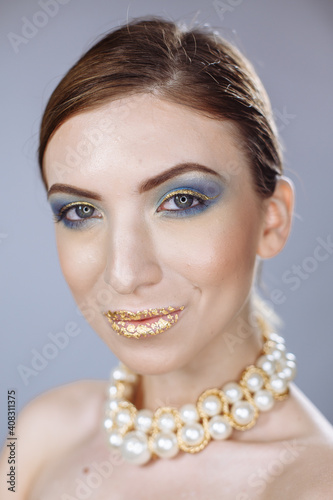 portrait of a girl with large white beads on a white background