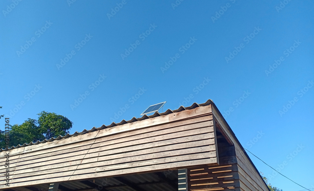 solar cell or Photovoltaics module (PV module, Solar module) on the roof with blue sky background.
