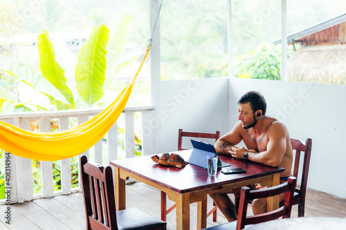 Digital nomad man working on a videoconference with tablet from the country of Costa Rica photo