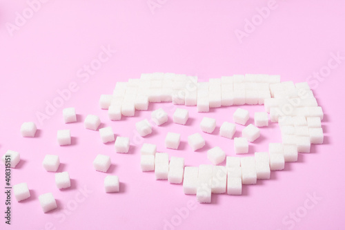 Heart shape of sugar cube isolated on pink background