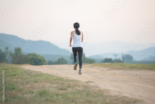 Young lady enjoying in a healthy lifestyle while jogging along a country road, exercise and Fitness and workout on outdoors.