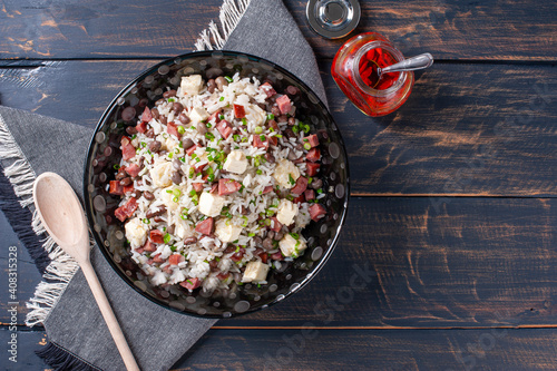 .Brazilian food called Baião de Dois. Very common in the north of the country. Made with rice, beans, sausage and rennet cheese. photo