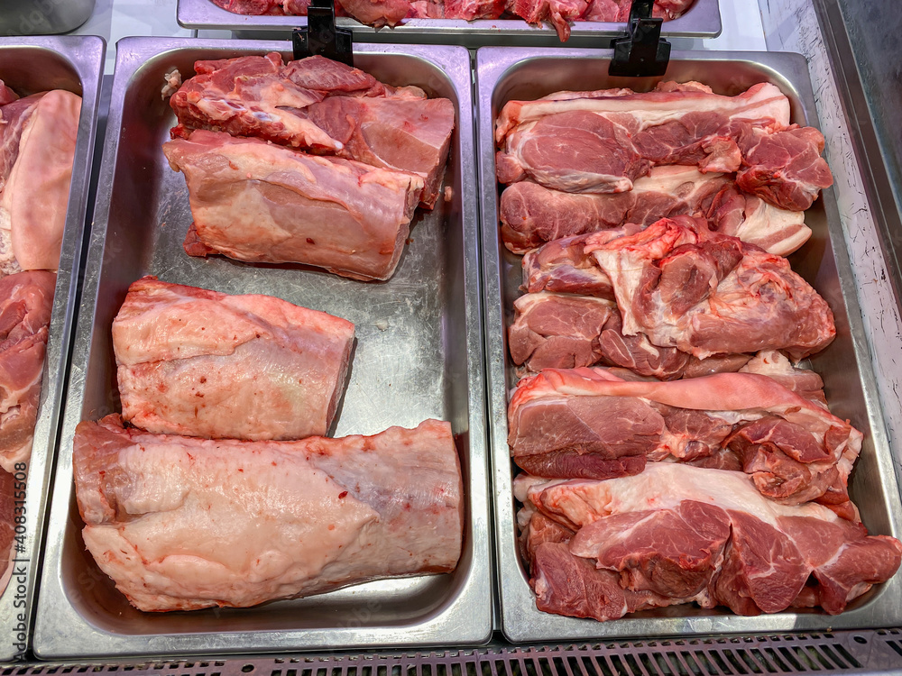 Raw pork meat for sale at butcher stall in the supermarket