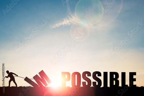 Mindset concept ,Silhouette man pulling  impossible to change possible wording on cloud sky and sunlight.