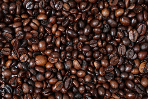 Concept wallpaper for a coffee shop. The scattered coffee beans are combined with a plain background. The texture of the coffee beans is very striking. Template background for mockup design.