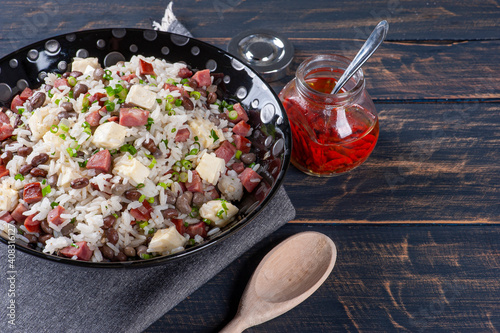 .Brazilian food called Baião de Dois. Very common in the north of the country. Made with rice, beans, sausage and rennet cheese. photo