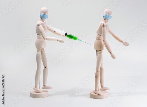 a wooden model of a human being vaccinated or injected into another person s buttock