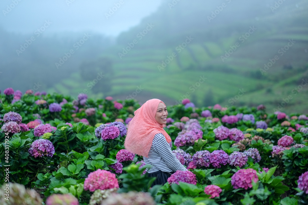 woman in the garden with flowers woman in the garden with flowers