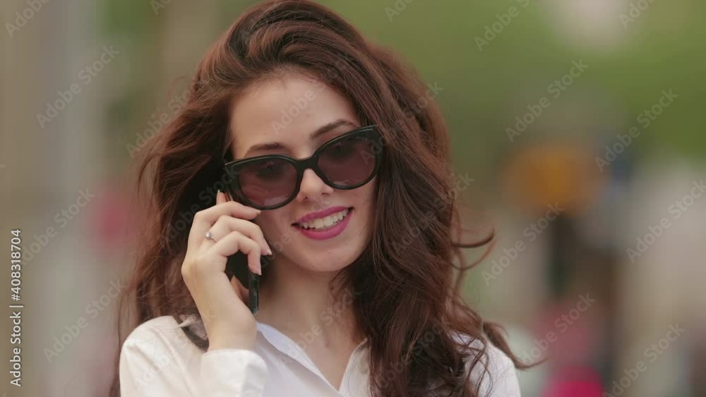 Young girl talking on the phone with sunglasses Young girl talking on the phone with sunglasses