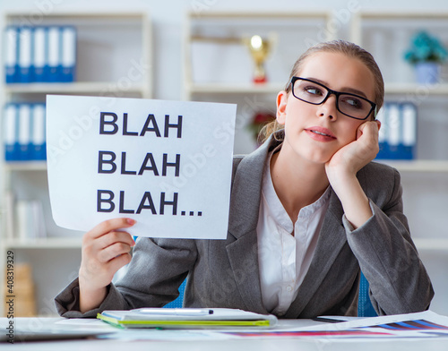 Businesswoman sitting in office with message photo