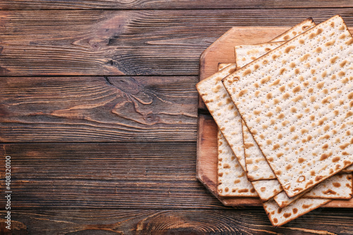 Jewish flatbread matza for Passover on wooden background