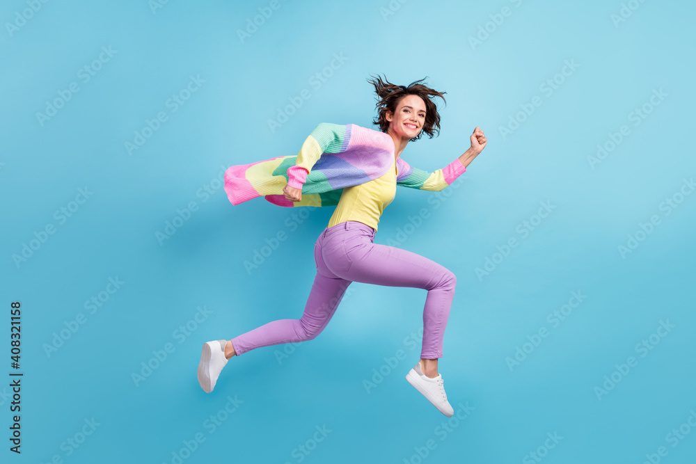 Photo portrait full body side view of running girl isolated on pastel blue colored background