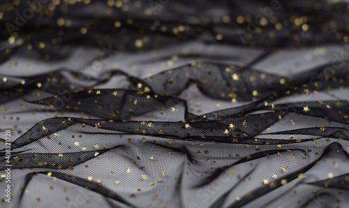 Draped black tulle with golden stars for background
