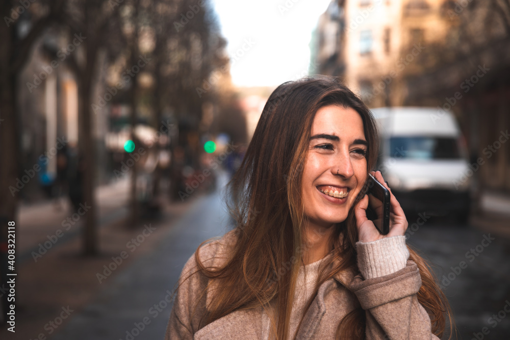 Young caucasian brunette woman using a smartphone at the street Young caucasian brunette woman using a smartphone at the street