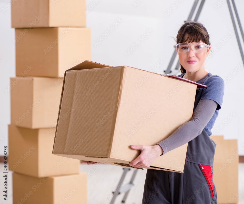 Woman contractor moving boxes in relocation concept