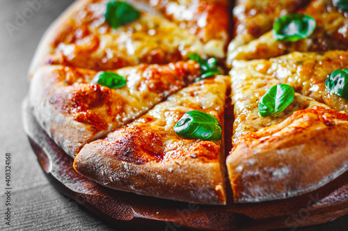Fotografie Pizza with Mozzarella cheese, Tomatoes, pepper, Spices and Fresh Basil