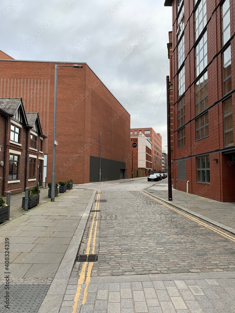 City street in Manchester City centre with landmark buildings and modern architecture. 