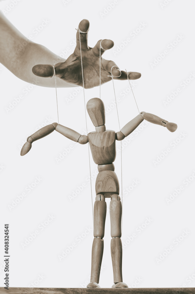 Concept of control. Marionette in human hand. Black and white. Concept of control. Marionette in human hand. Black and white.