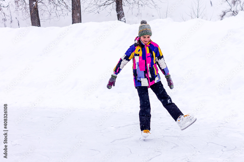 Fototapeta premium Happy contented girl skates on the city ice rink.