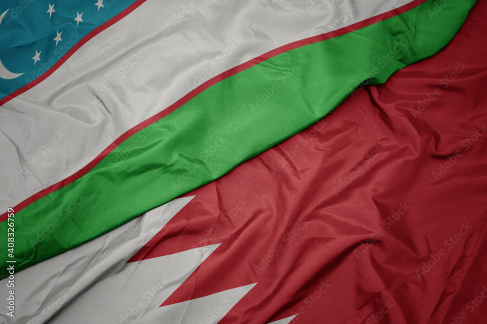 waving colorful flag of bahrain and national flag of uzbekistan.