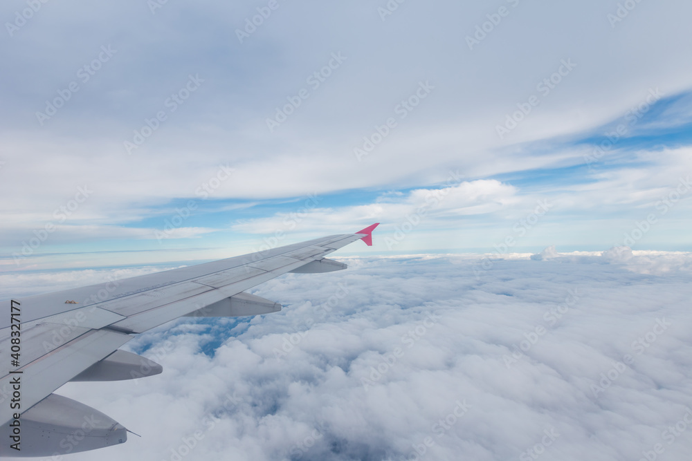 Obraz premium view from airplane window with white cloud and blue sky
